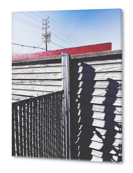 steel fence and wooden fence with red building and blue sky background in the city Acrylic prints by Timmy333