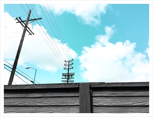 electric pole with wooden wall and blue cloudy sky in the city Art Print by Timmy333