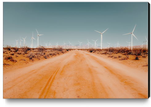 Wind turbine in the desert with sandy road at Kern County California USA Canvas Print by Timmy333