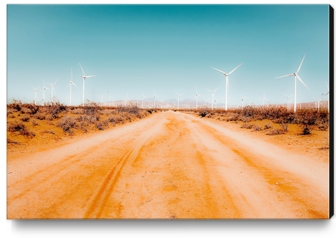 Wind turbine and sandy road desert with blue sky in California USA Canvas Print by Timmy333