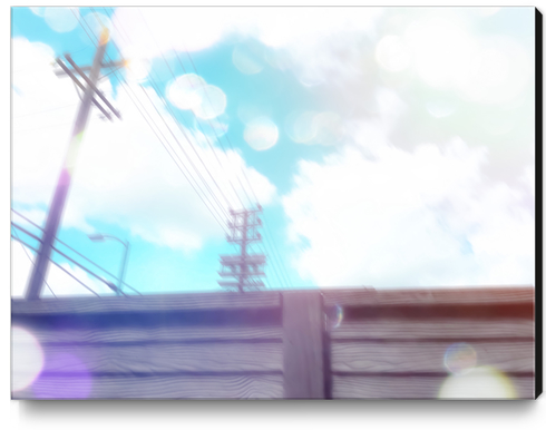 cloudy blue sky and electric pole and wood wall in the city Canvas Print by Timmy333