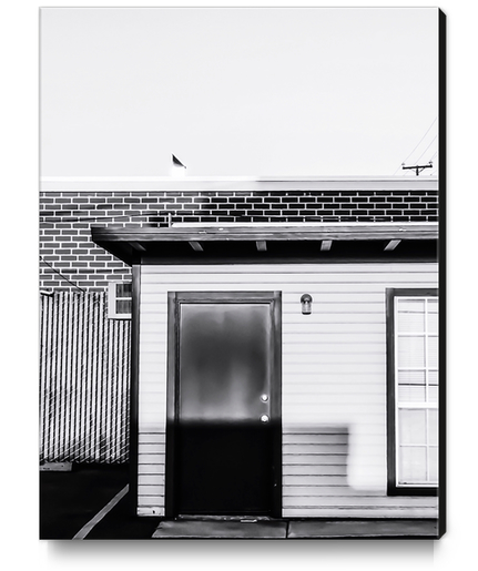 wood building with brick building background in black and white Canvas Print by Timmy333