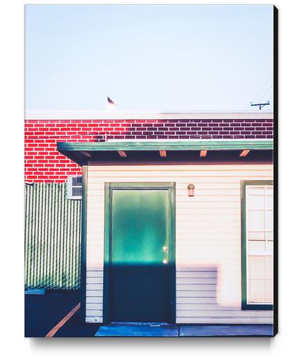 green wood building with brick building in the city Canvas Print by Timmy333