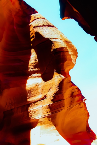 Orange sandstone abstract with blue sky at Antelope Canyon, Arizona, USA by Timmy333