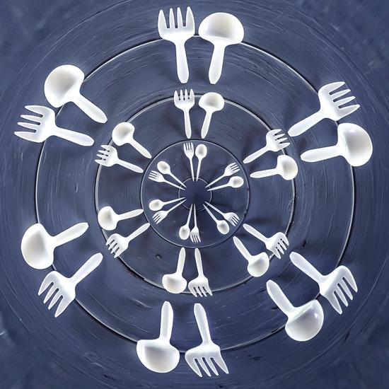 forks and spoons on the wooden table in circle pattern by Timmy333