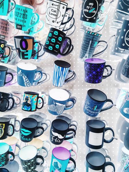 colorful mugs hanging on the white wall by Timmy333