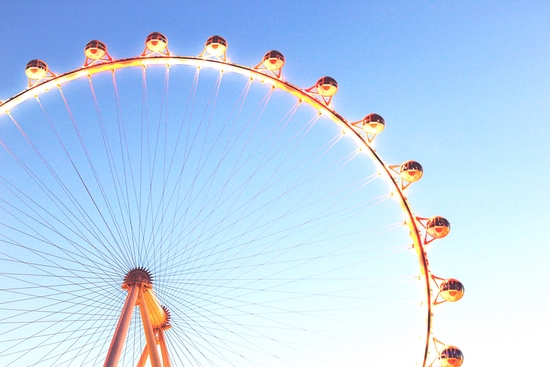 orange Ferris Wheel in the city with blue sky  by Timmy333