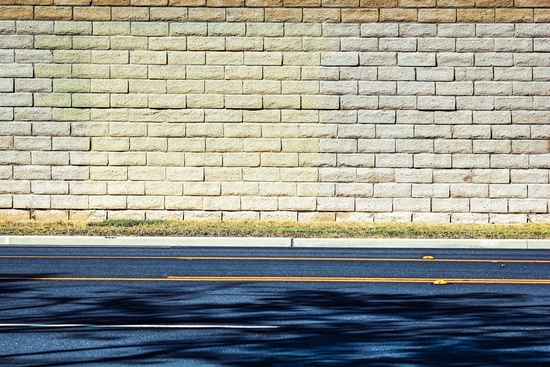 road with shadows and brick wall background by Timmy333