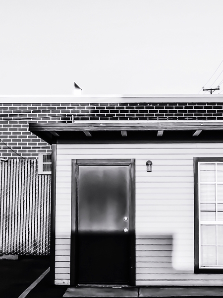 wood building with brick building background in black and white by Timmy333